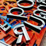 Vibrant neon letters arranged artistically, showcasing a unique signage design.